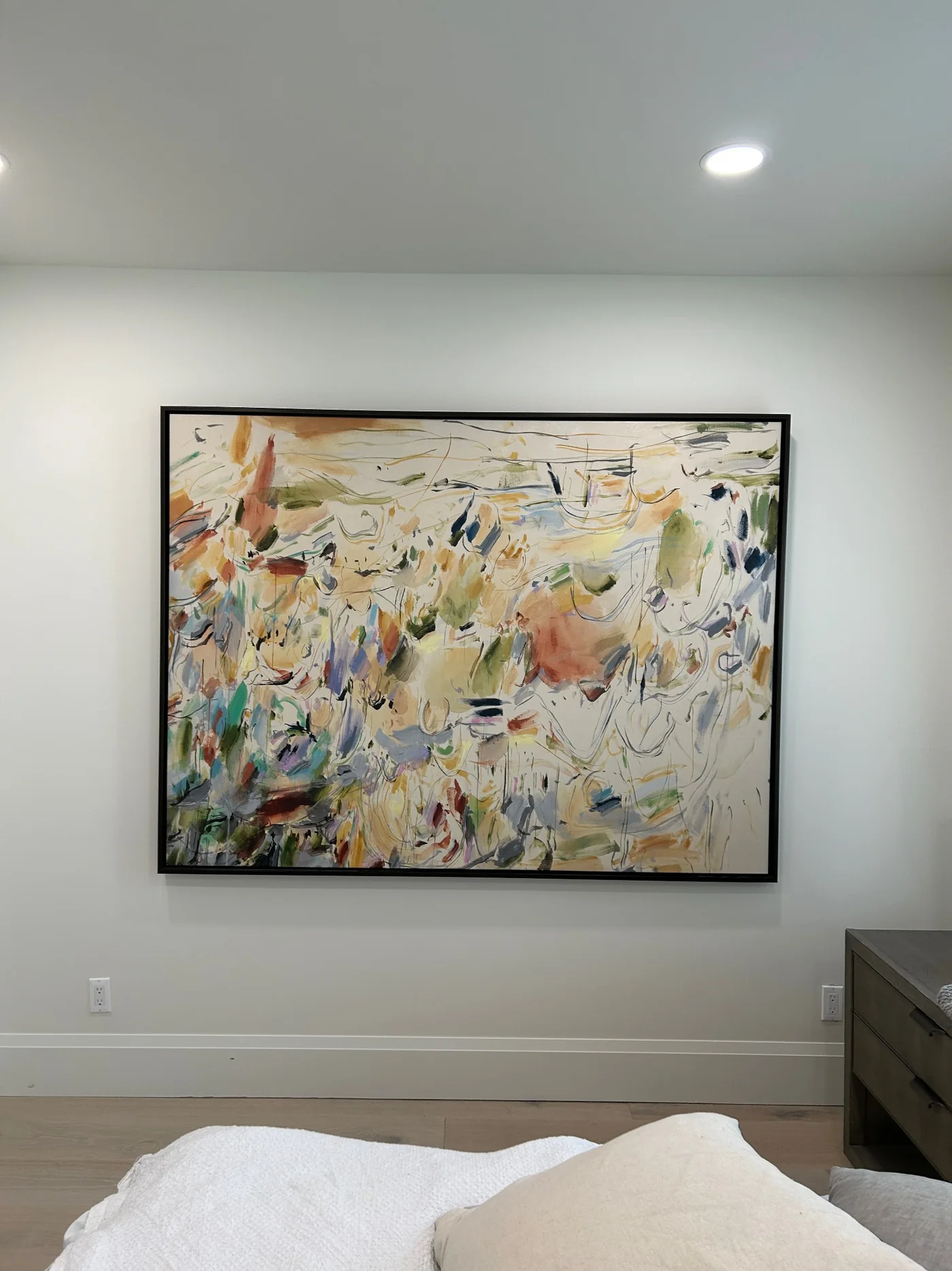 Framed abstract artwork installed in a bedroom